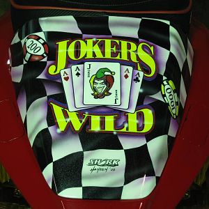 An impish grin and a winning hand out back.